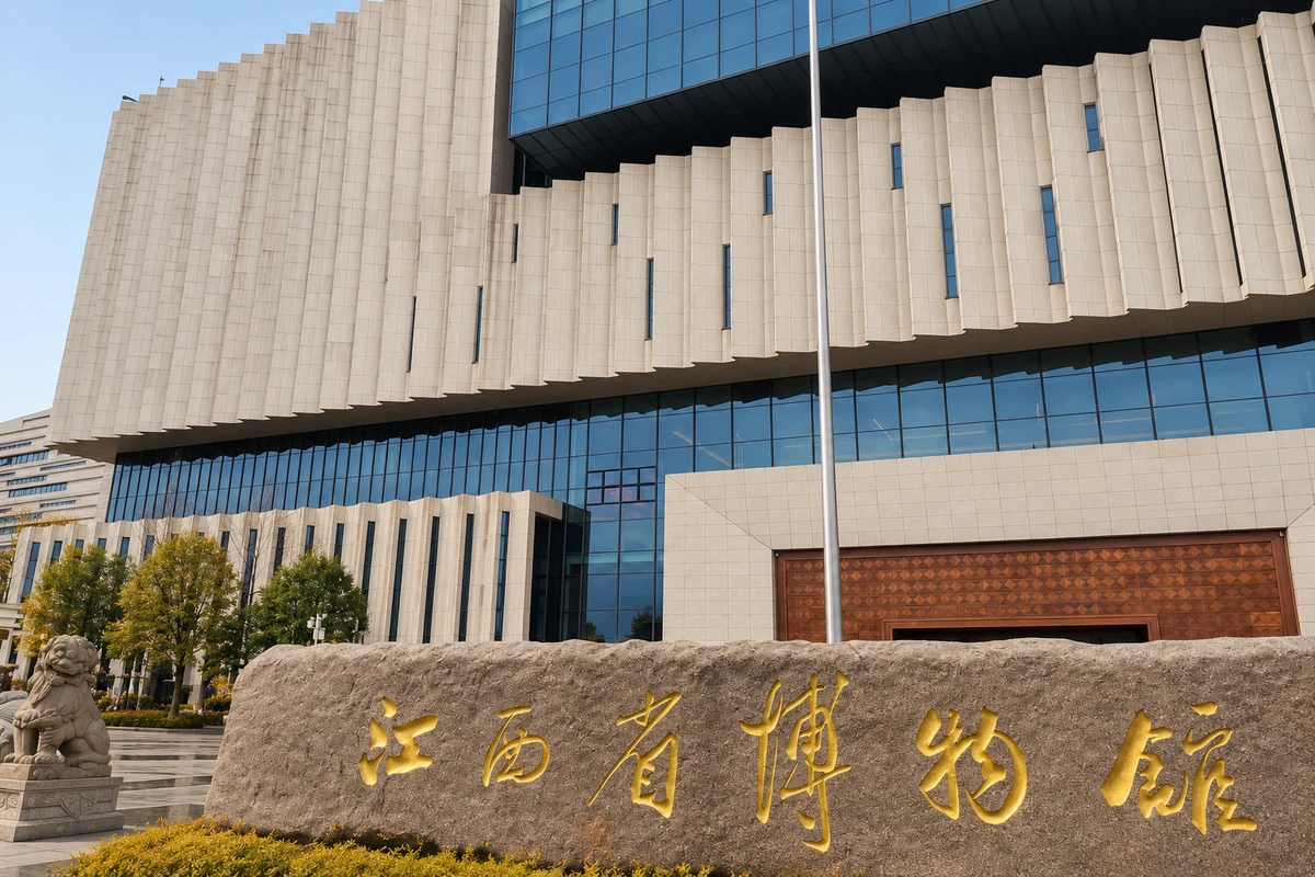 题名石旁的建筑尺度：馆名石、玻璃底层与上方浅色折面把视线从地面引向立面；场景对应赣江北大道新馆，题名不作为生成文字的识别依据。